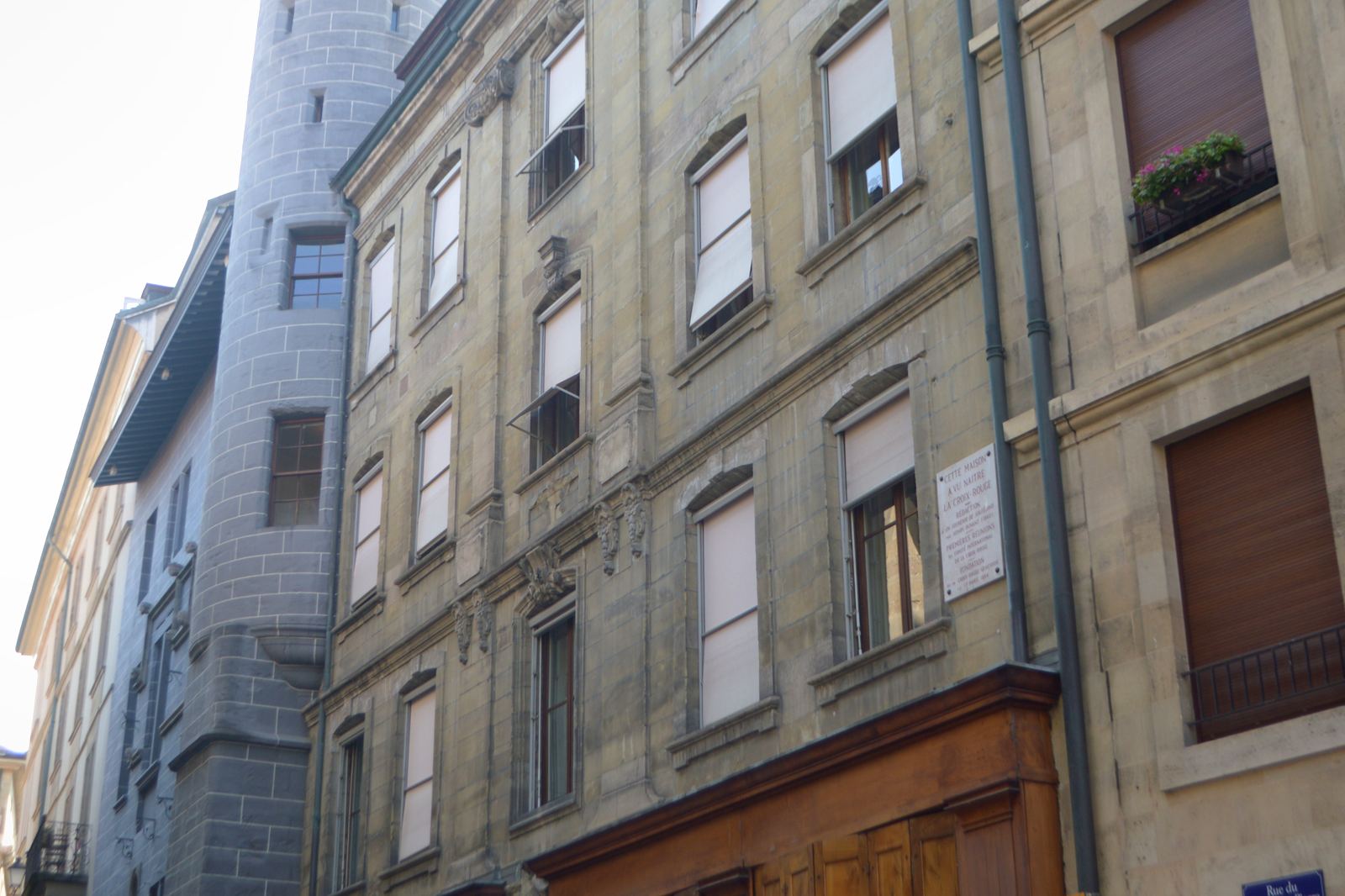 A quiet street of stone facades in an old European town.
